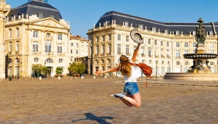 Jeune femme enjouée sur la Place de la Bourse de Bordeaux